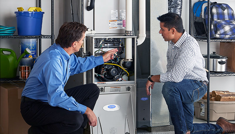 HVAC technician evaluating a furnace for repair or replacement in North Salt Lake