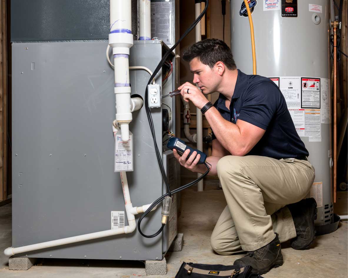 HVAC technician performing a furnace tune-up in North Salt Lake