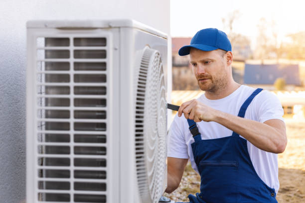 HVAC technician servicing an outdoor air conditioning unit in North Salt Lake