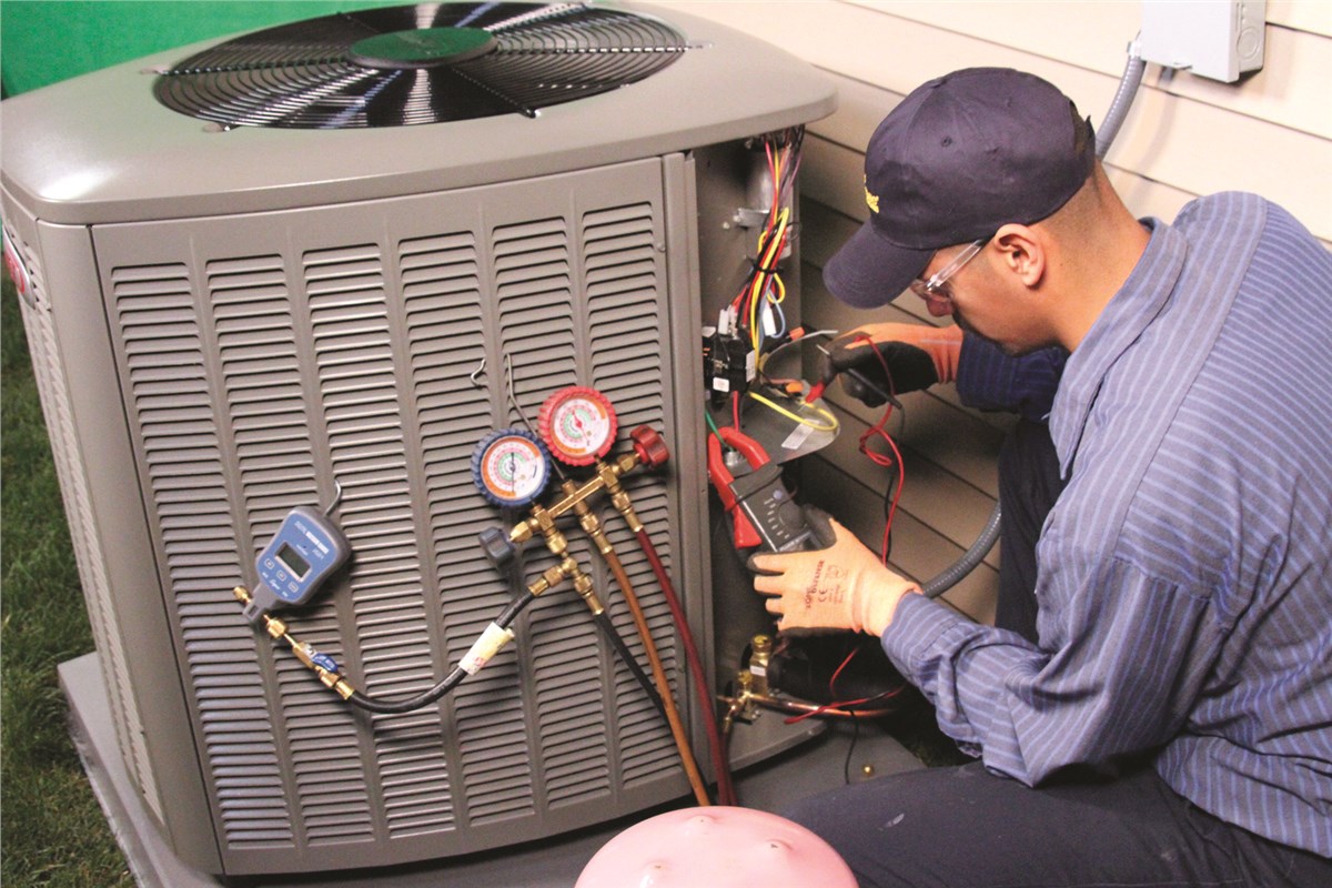 HVAC technician testing an outdoor air conditioning unit in North Salt Lake